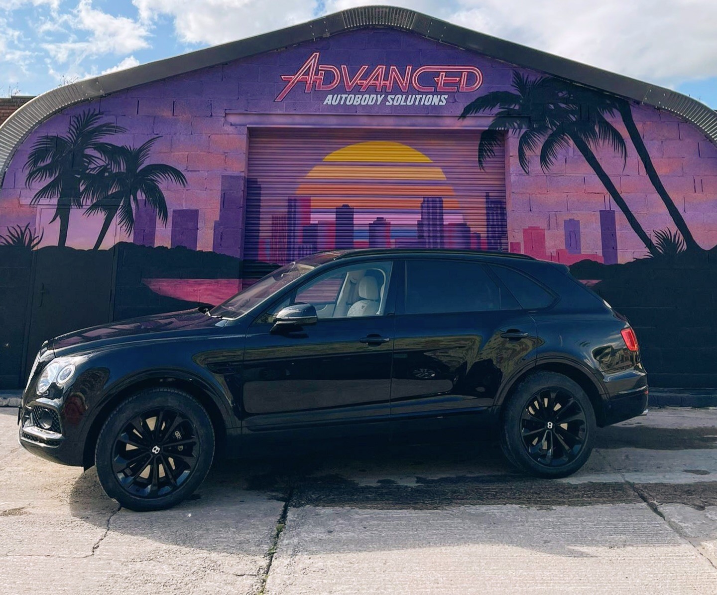 Completed bumper and paint repair on a dark vehicle